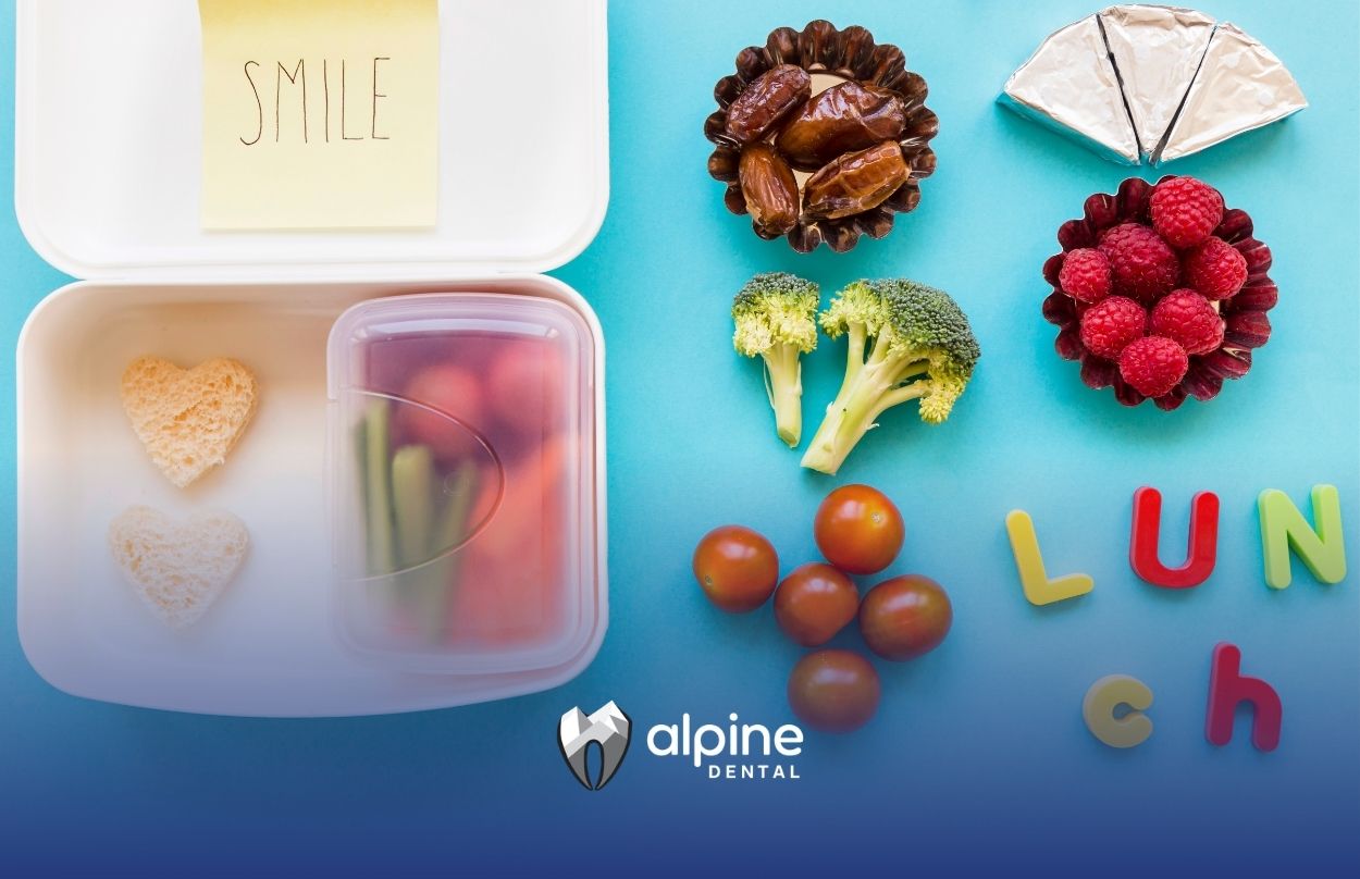 Healthy lunchbox with heart-shaped sandwiches, fresh fruits, vegetables, and nutritious snacks arranged for kids.