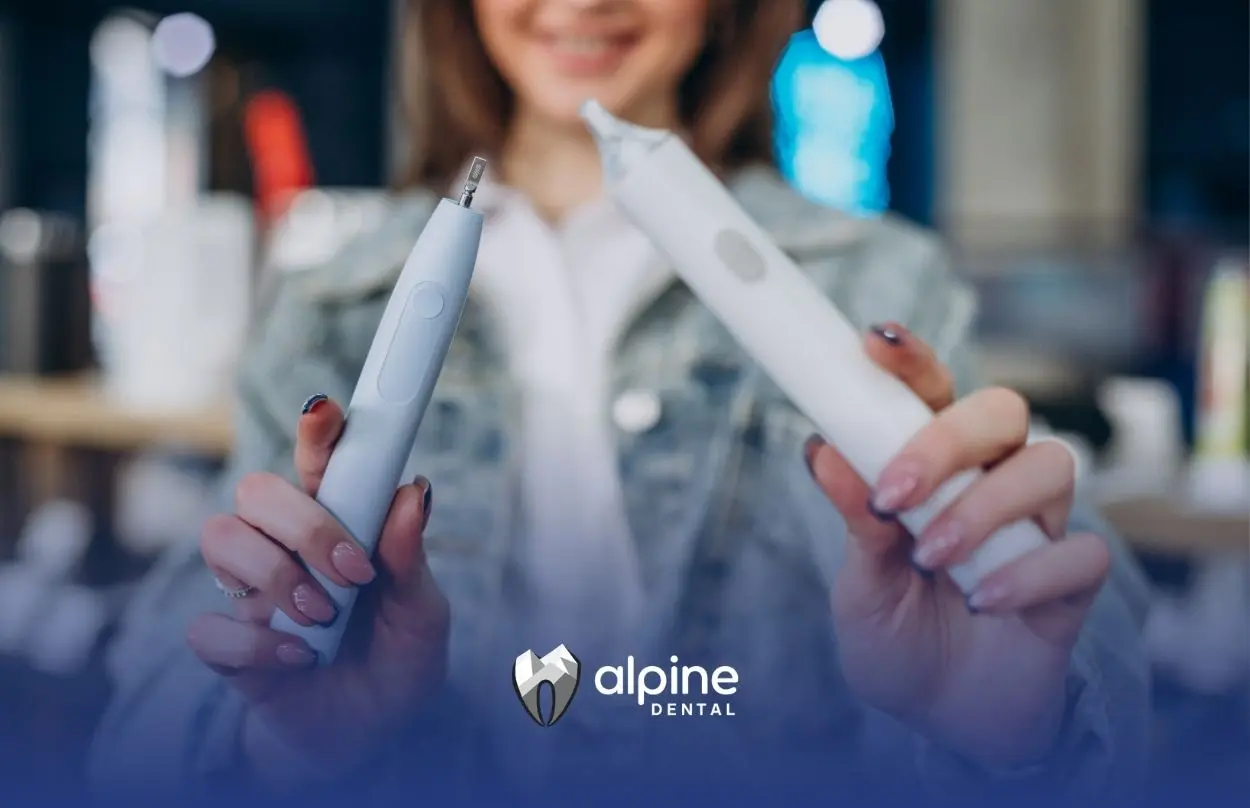 Person comparing a water flosser and traditional dental floss tools to demonstrate oral hygiene options and cleaning methods.