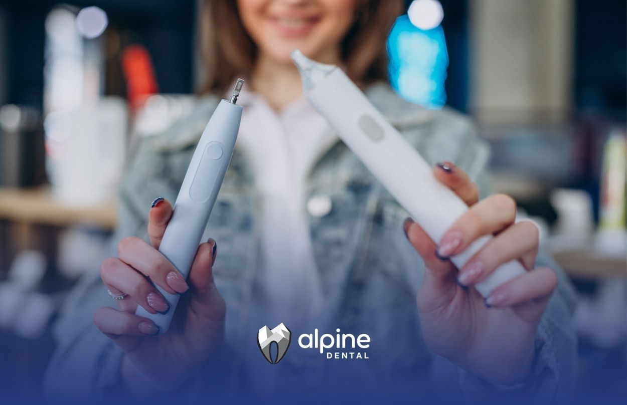 Person comparing a water flosser and traditional dental floss tools to demonstrate oral hygiene options and cleaning methods.
